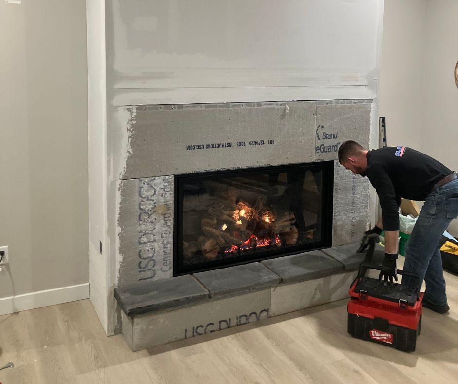 supreme employee working on fireplace